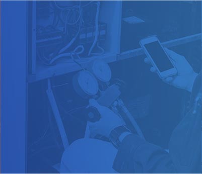 Technician using a smartphone while checking HVAC gauges, emphasizing air conditioning and heating repair services by Crowe's Comfort Solutions in Pooler, GA.