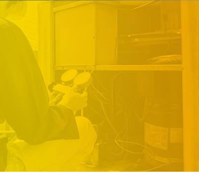 Technician working on HVAC system with gauges, emphasizing heating and air conditioning repair services for Crowe's Comfort Solutions.