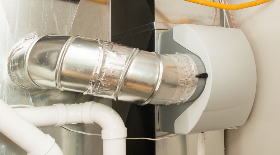 Whole-home humidifier connected to HVAC system, enhancing indoor air quality and humidity control for improved comfort.